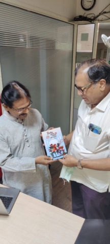 Dr. Bhanu Pratap Singh, author of 'Mere Husband Mujhko Pyar Nahi Karte', presents the book to renowned neurosurgeon Dr. RC Mishra